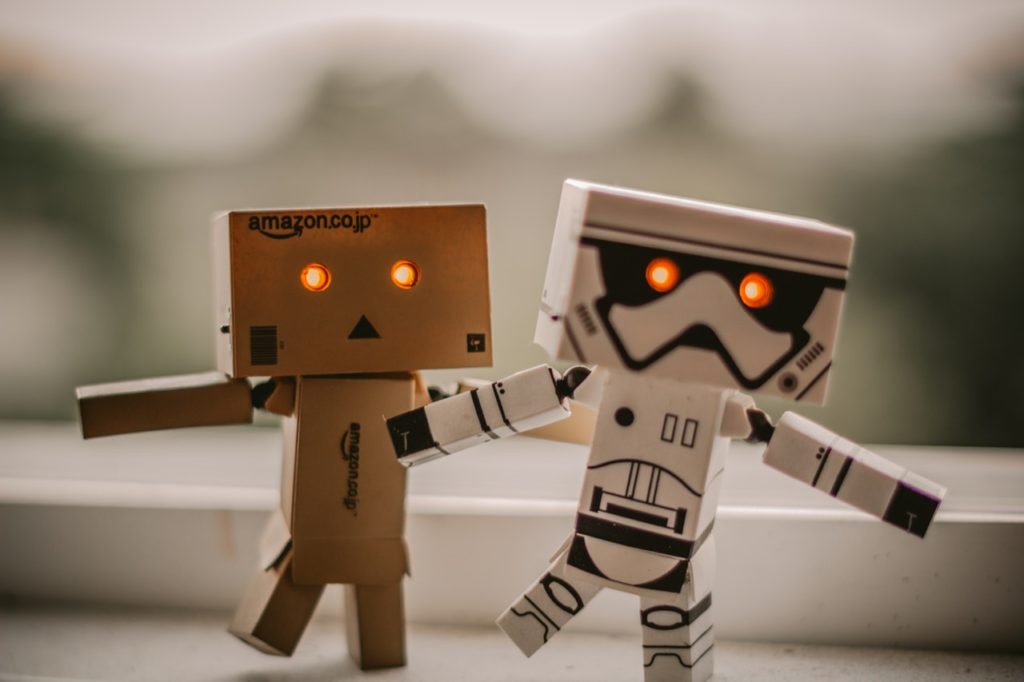 An Amazon and storm trooper robot holding hands