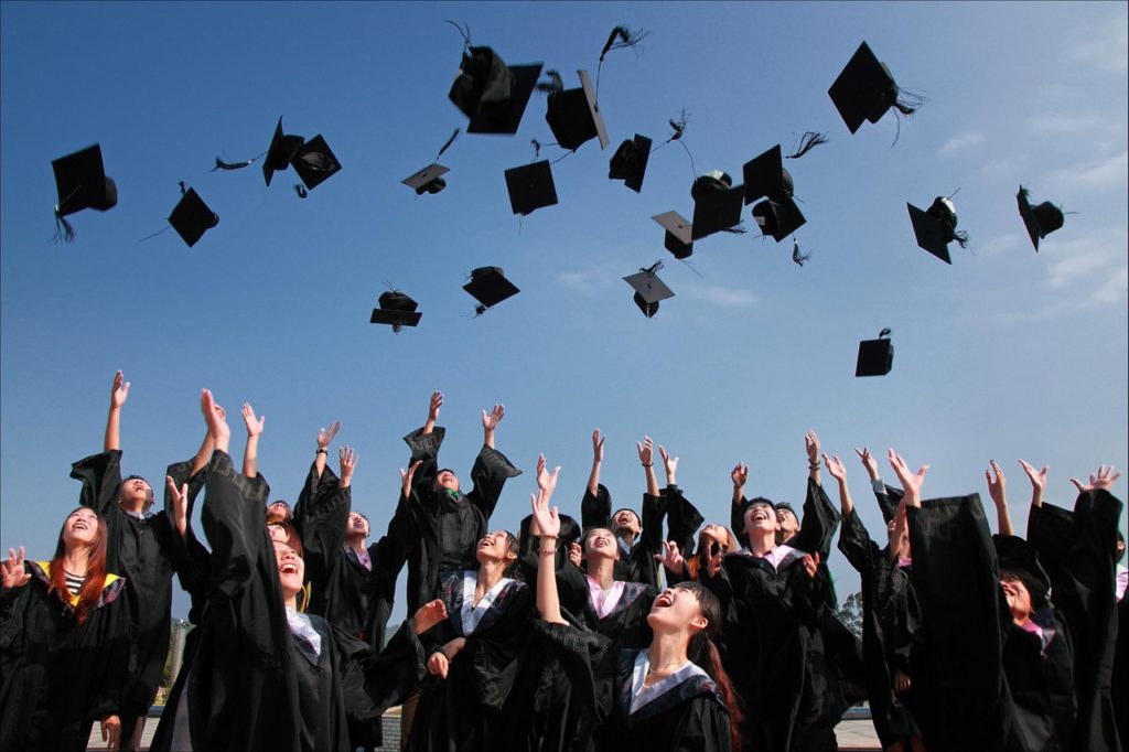 Graduation students throwing caps in the air