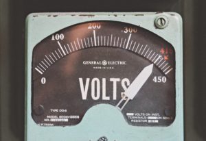 Grey voltmeter with a white needle