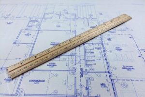 Blueprint with a ruler lying across it