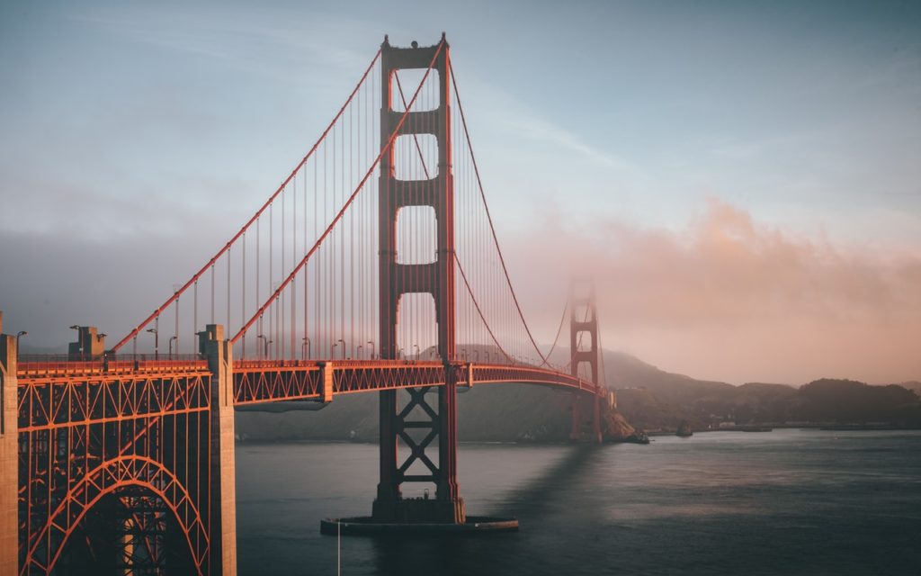 Golden gate bridge at sunset with low clouds