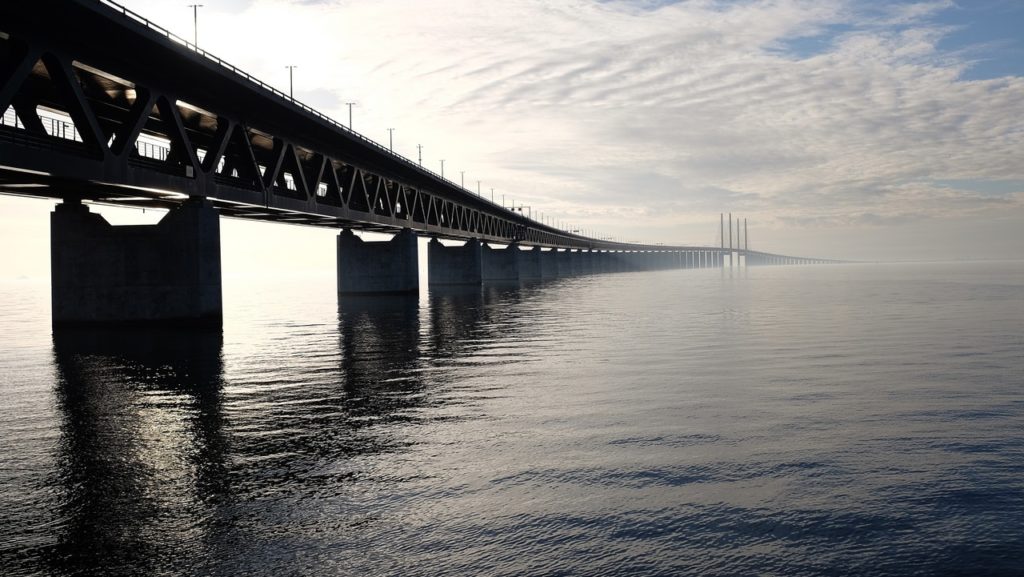 Grey concrete bridge on body of water