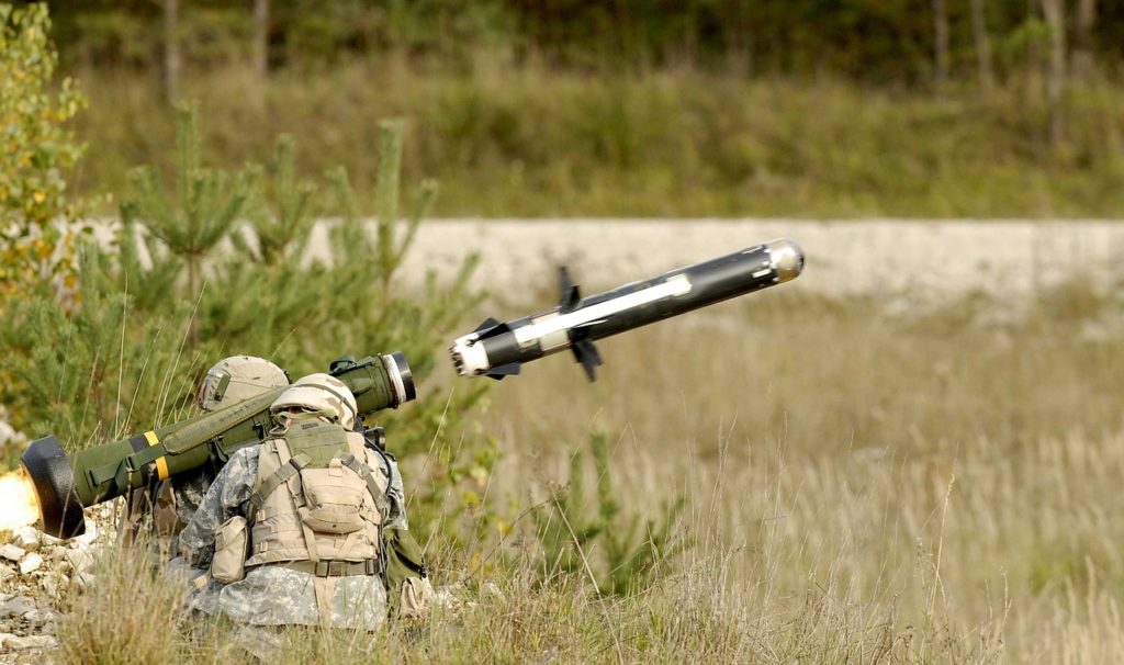 Soldiers launching anti-tank missile in camouflage