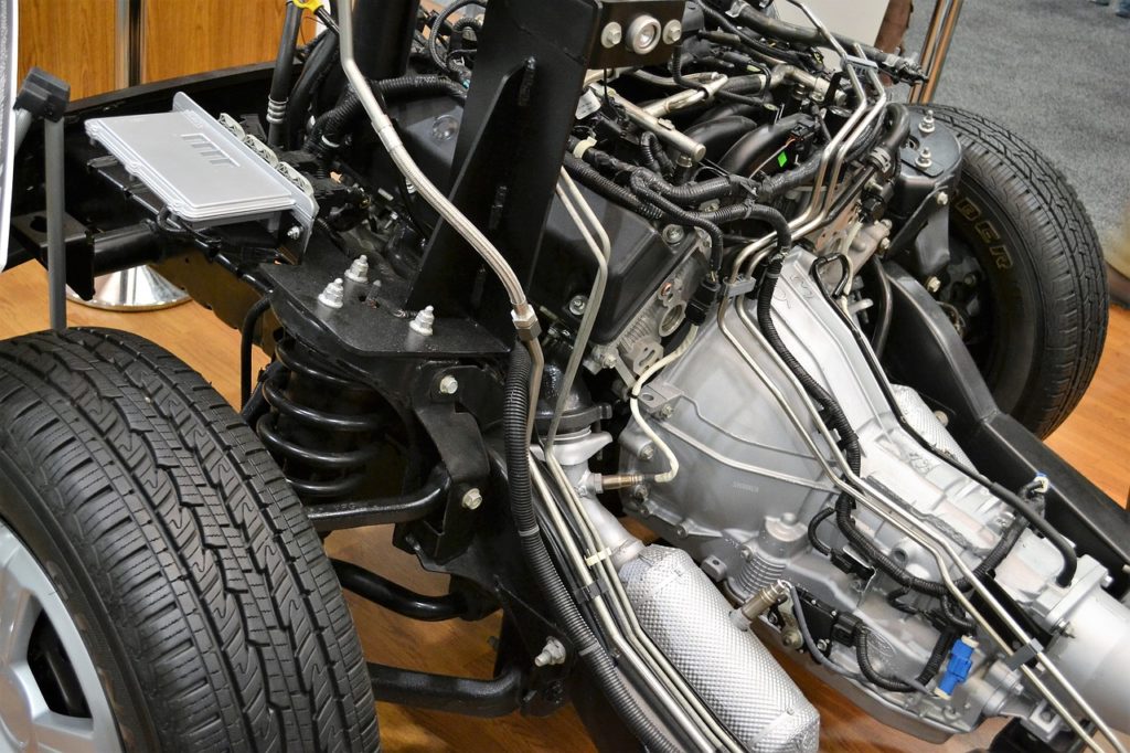 Disassembled car showing engine and suspension