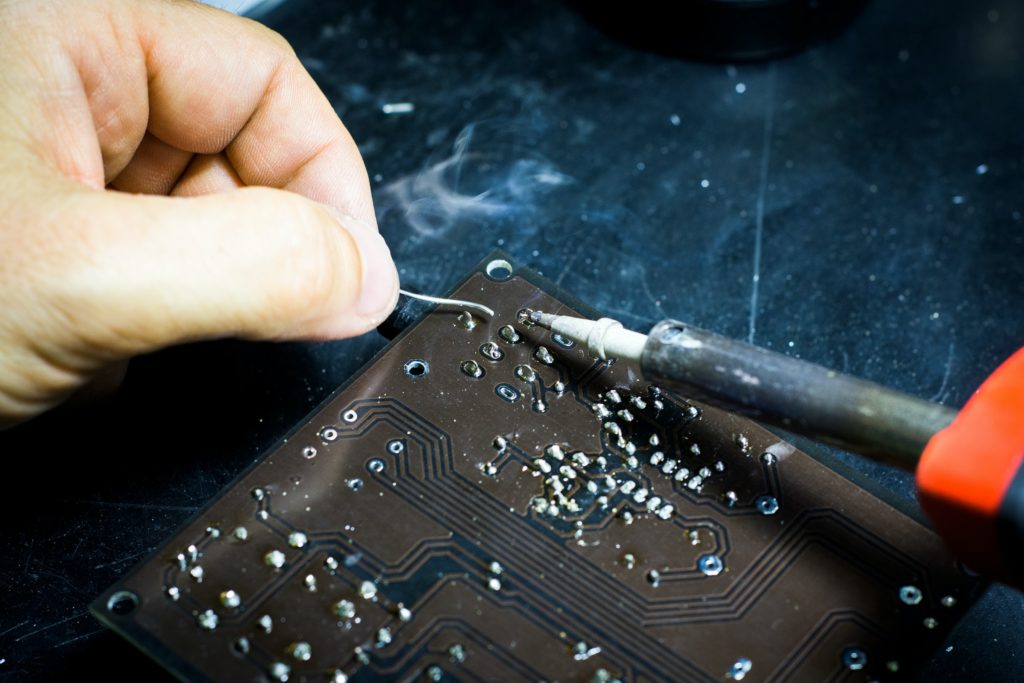 Person soldering a circuit board