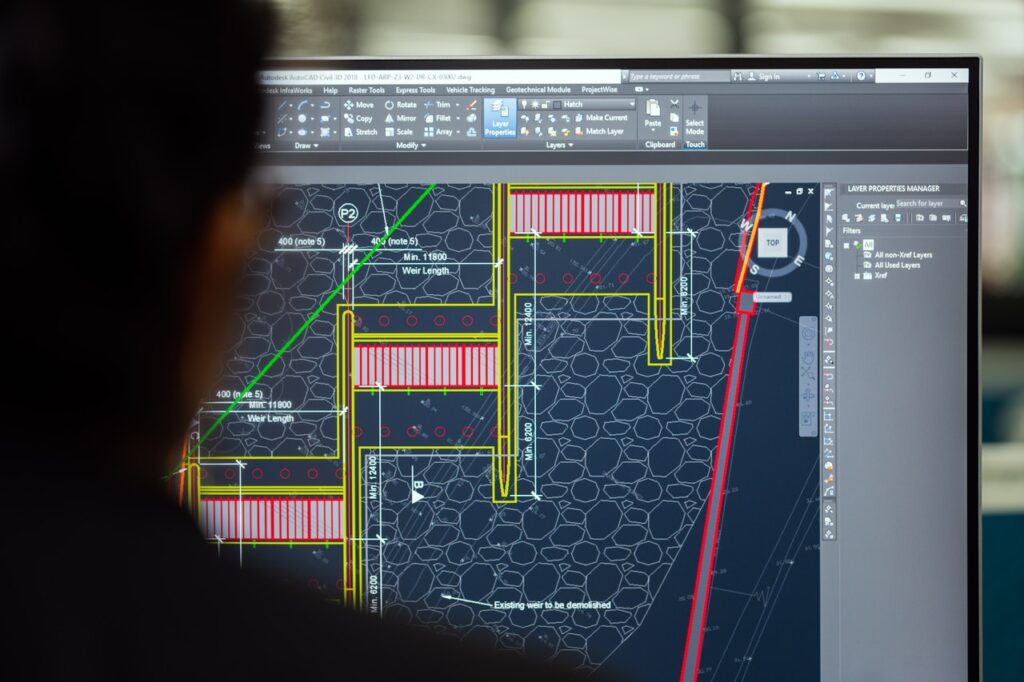 Engineer using AutoCAD to draw a dam