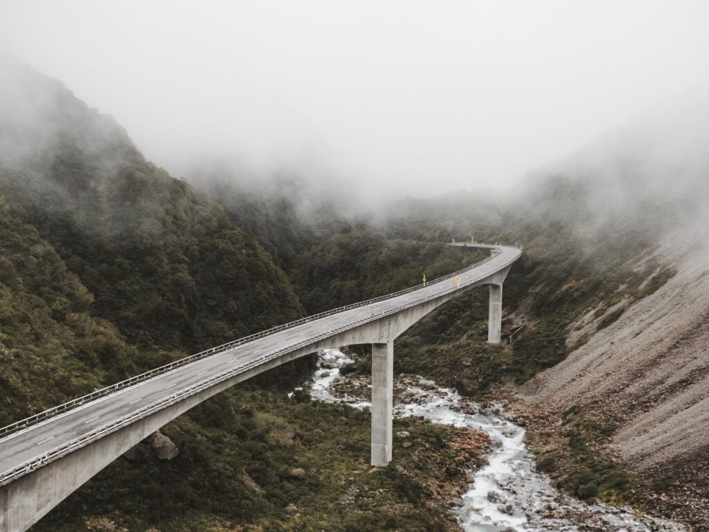 High bridge over foggy mountains
