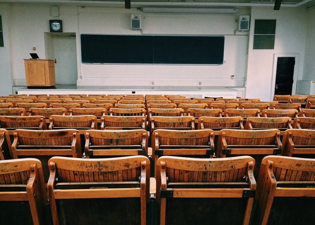 Empty lecture room with wooden chairs