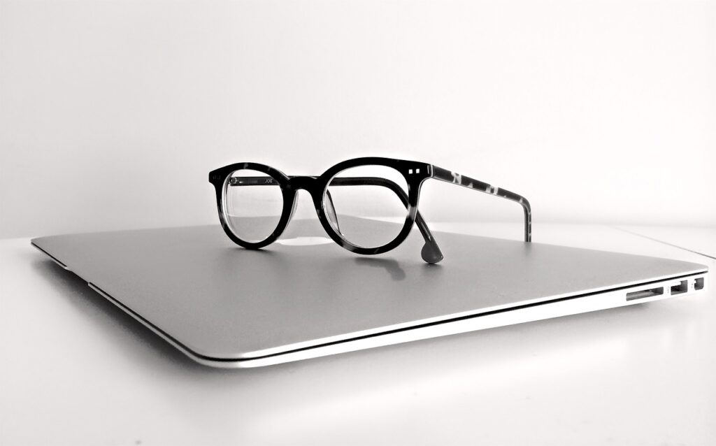 Glasses on top of a laptop