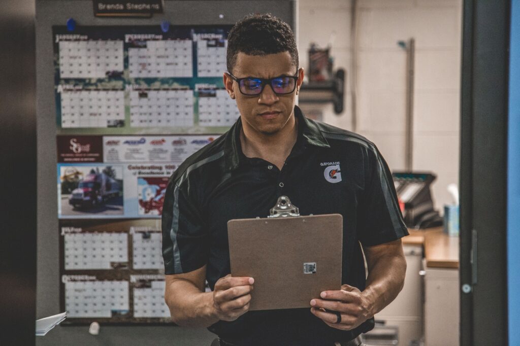 Manufacturing engineer looking at clipboard
