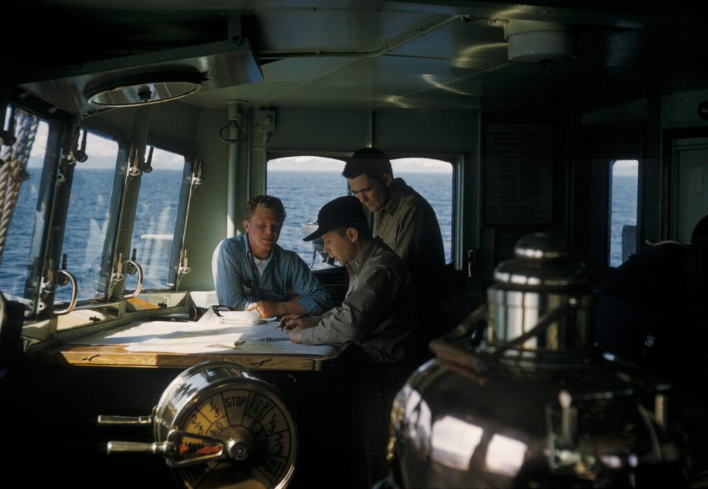 Marine engineers looking at documents
