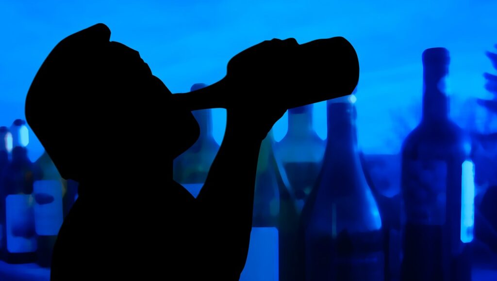 Silhouette of man drinking